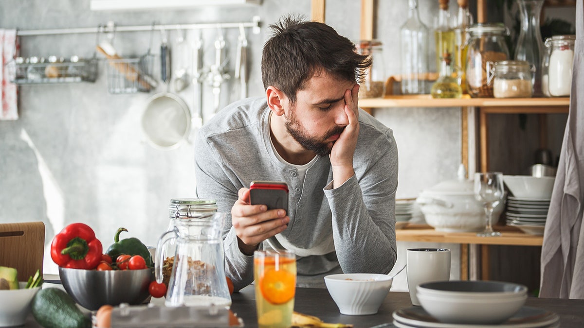 Sad man with telephone breakfast