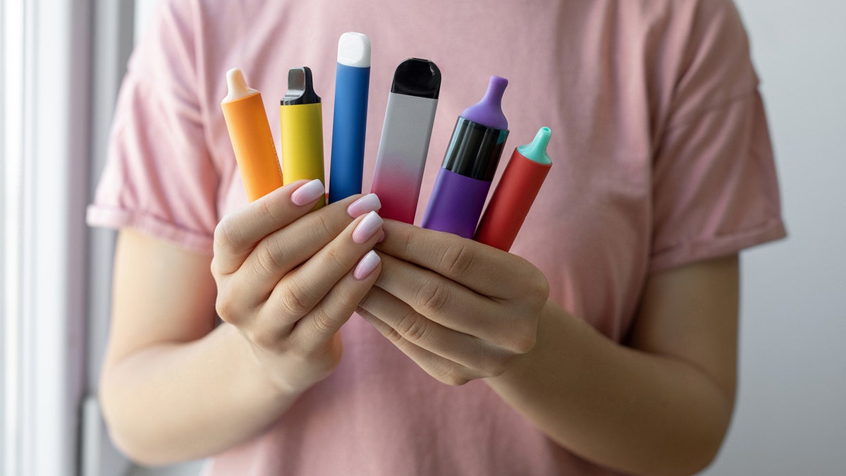 Vape cigarettes in the woman's hand
