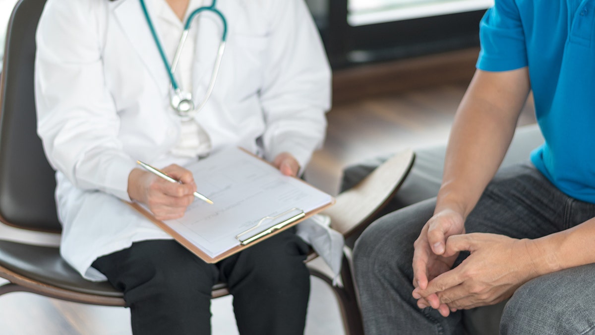 Doctor sitting with patient